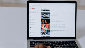 Browsing YouTube trending videos on laptop