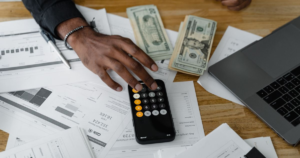 Finances management with calculator and cash