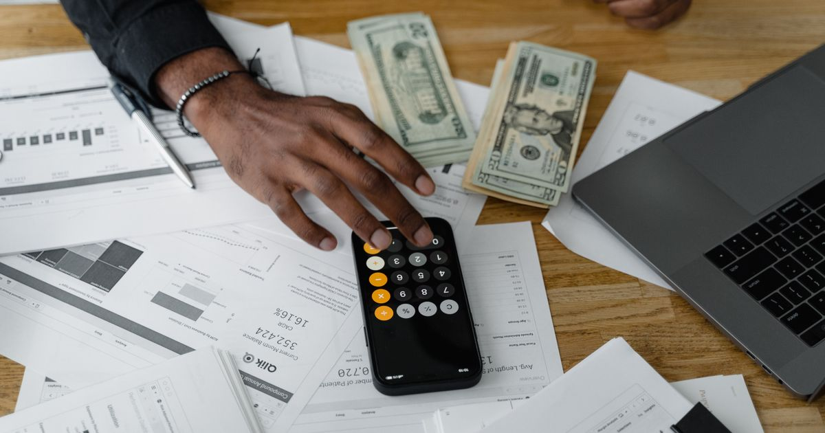 Finances management with calculator and cash