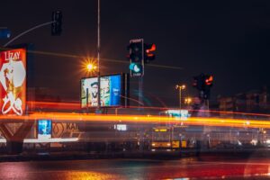 Nighttime city intersection with light trails