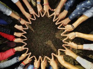 Hands forming a circle on grass