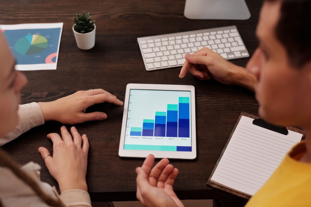 Team analyzing growth chart on tablet