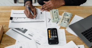 seo roi Analyzing financial documents with cash and calculator
