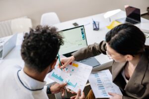 Analyzing financial charts in office meeting