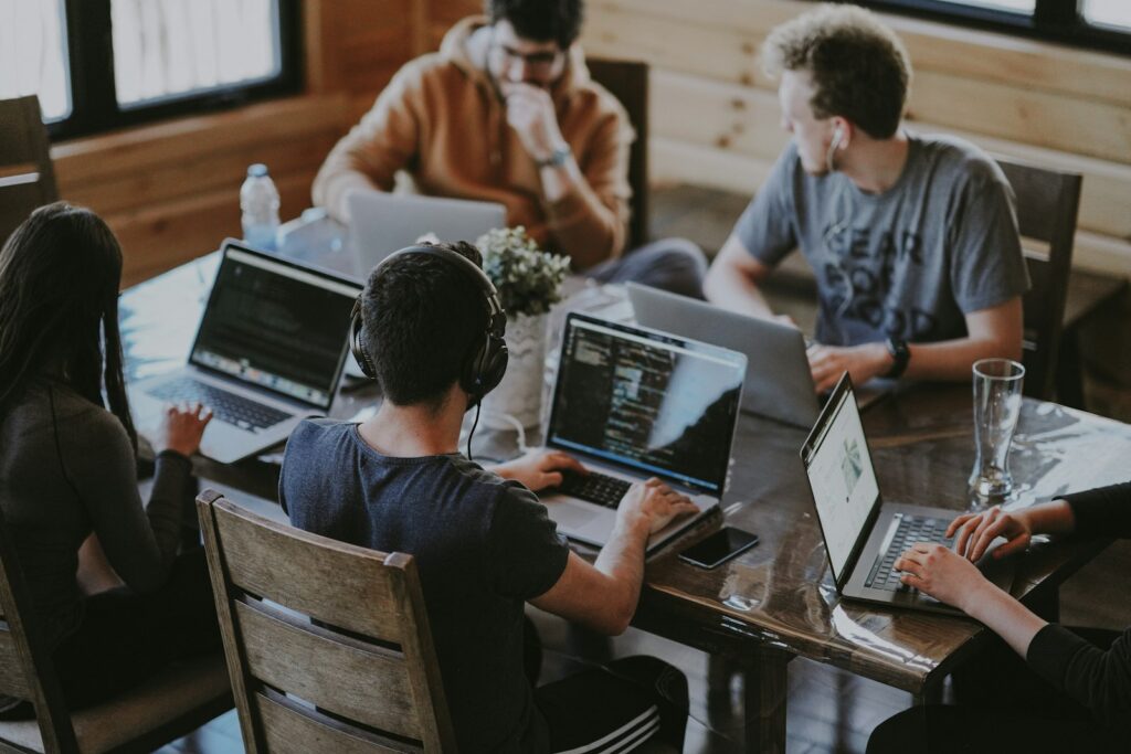 In-house marketing team working together on laptops