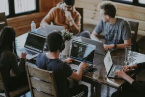 In-house marketing team working together on laptops