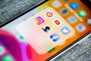 Social media app icons on a smartphone for a brand audit