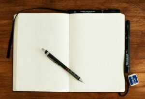 Pen on an open notebook for planning a long-tail keyword strategy