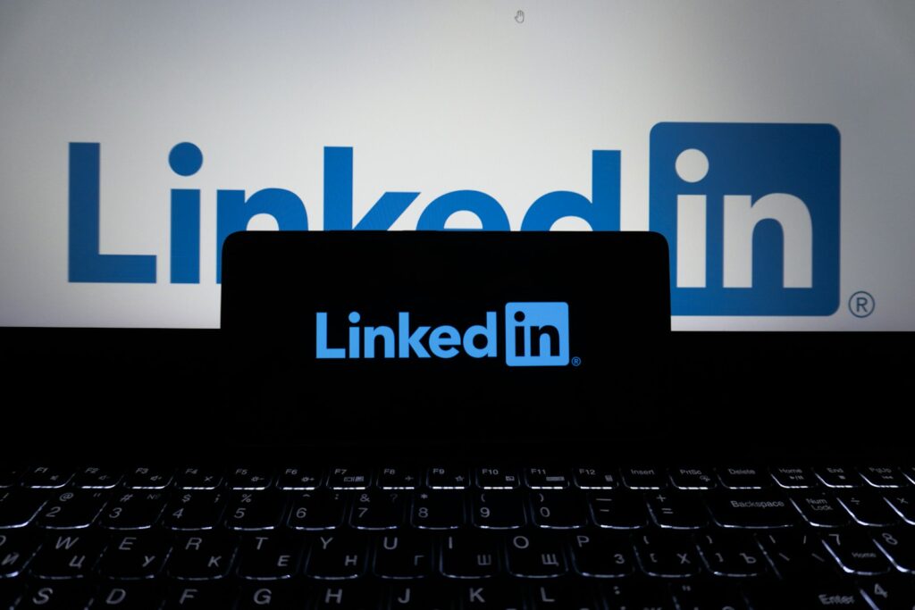 LinkedIn on a phone and laptop for founder thought leadership