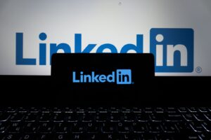 LinkedIn on a phone and laptop for founder thought leadership